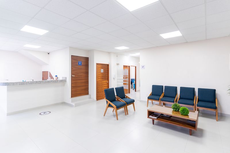 Clean, well-kept medical office waiting room with reception desk and seating.